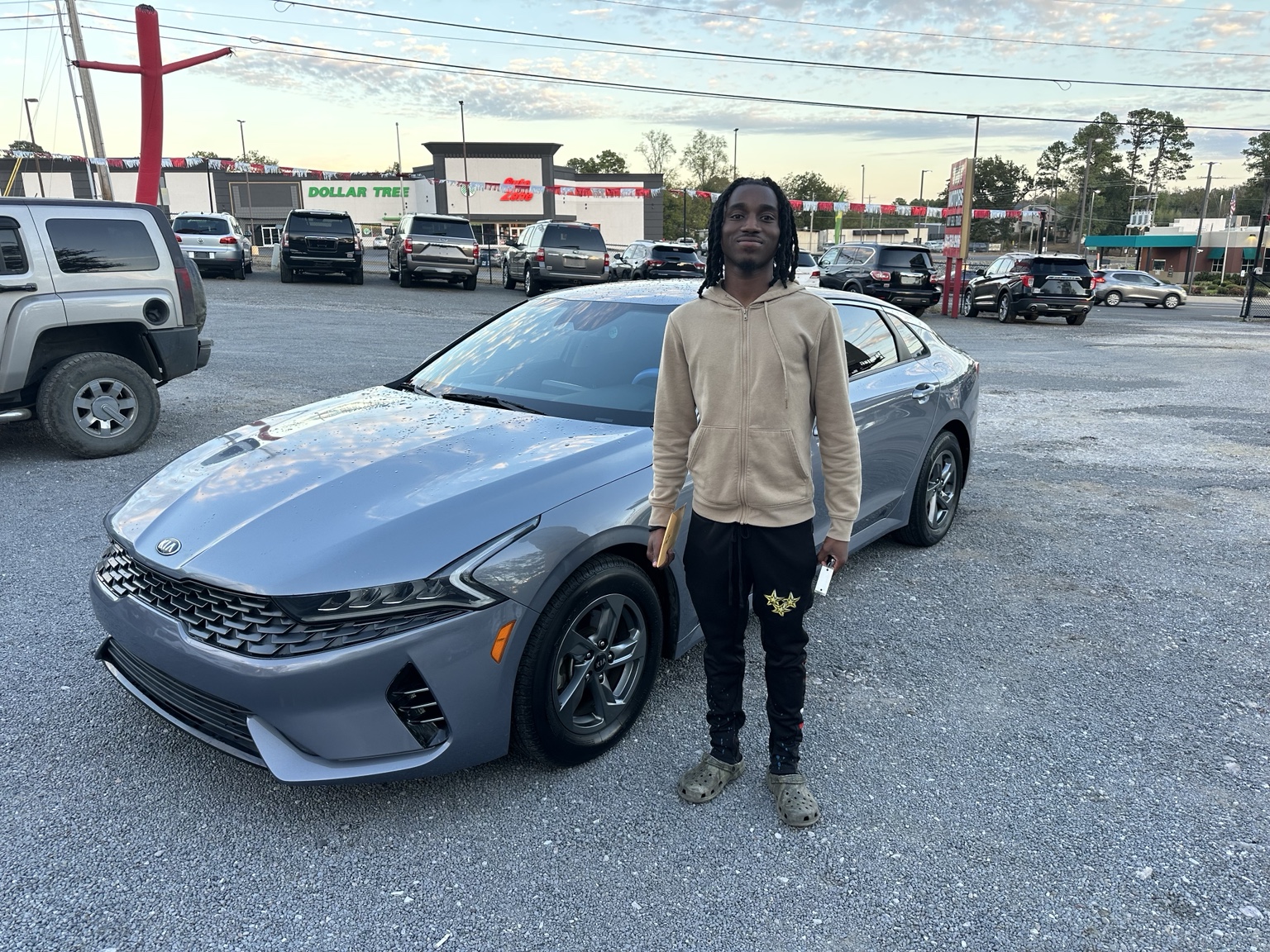 Jeremiah with their 2021 Kia K5 LXS purchased from TMT Motors